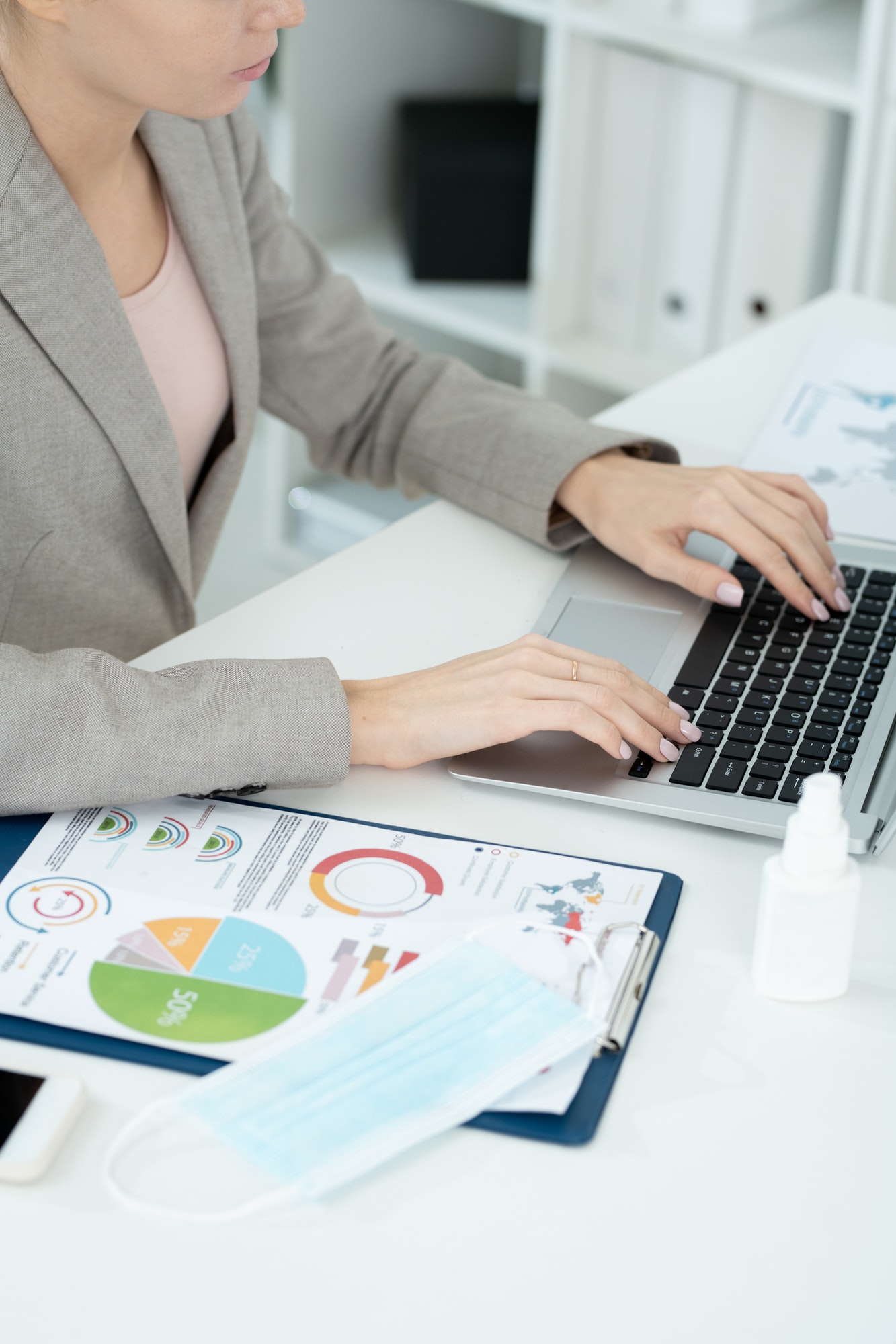 Hands of young contemporary businesswoman or secretary during network