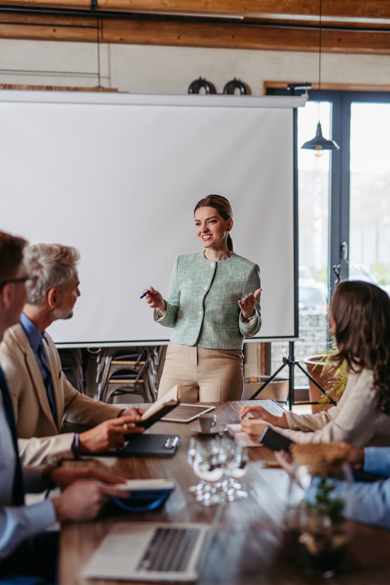 Female CEO manager leading corporate meeting in office.